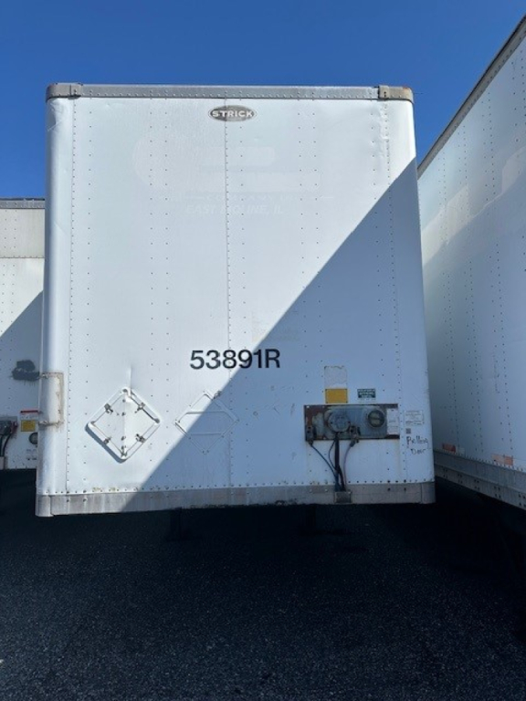 Rear view of a white Strick roll door trailer with 53891R and Strick logo.