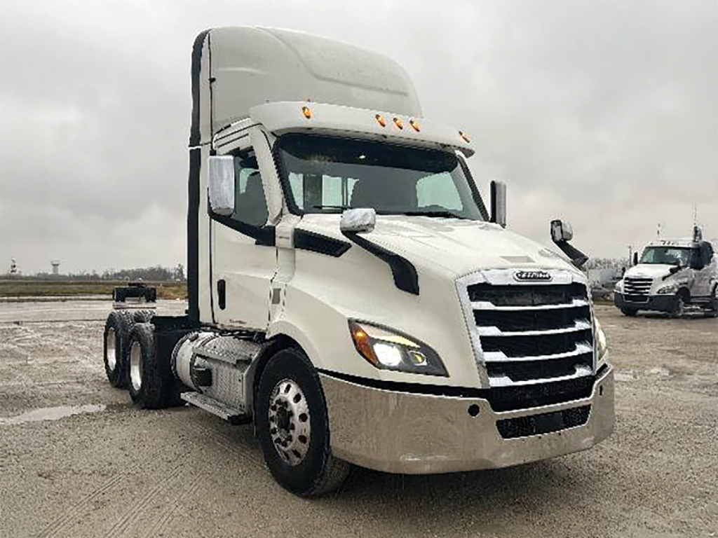 Truck view showing 2021 Freightliner Cascadia 116 conventional daycab front-left angle with grille, headlights, and cab-top sleeper