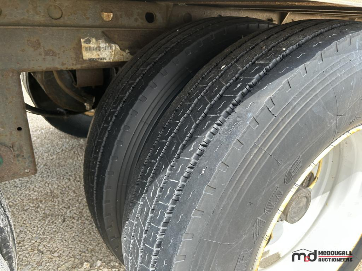 Trailer rear view showing dual axles and tires of a 53' dry van semi trailer.