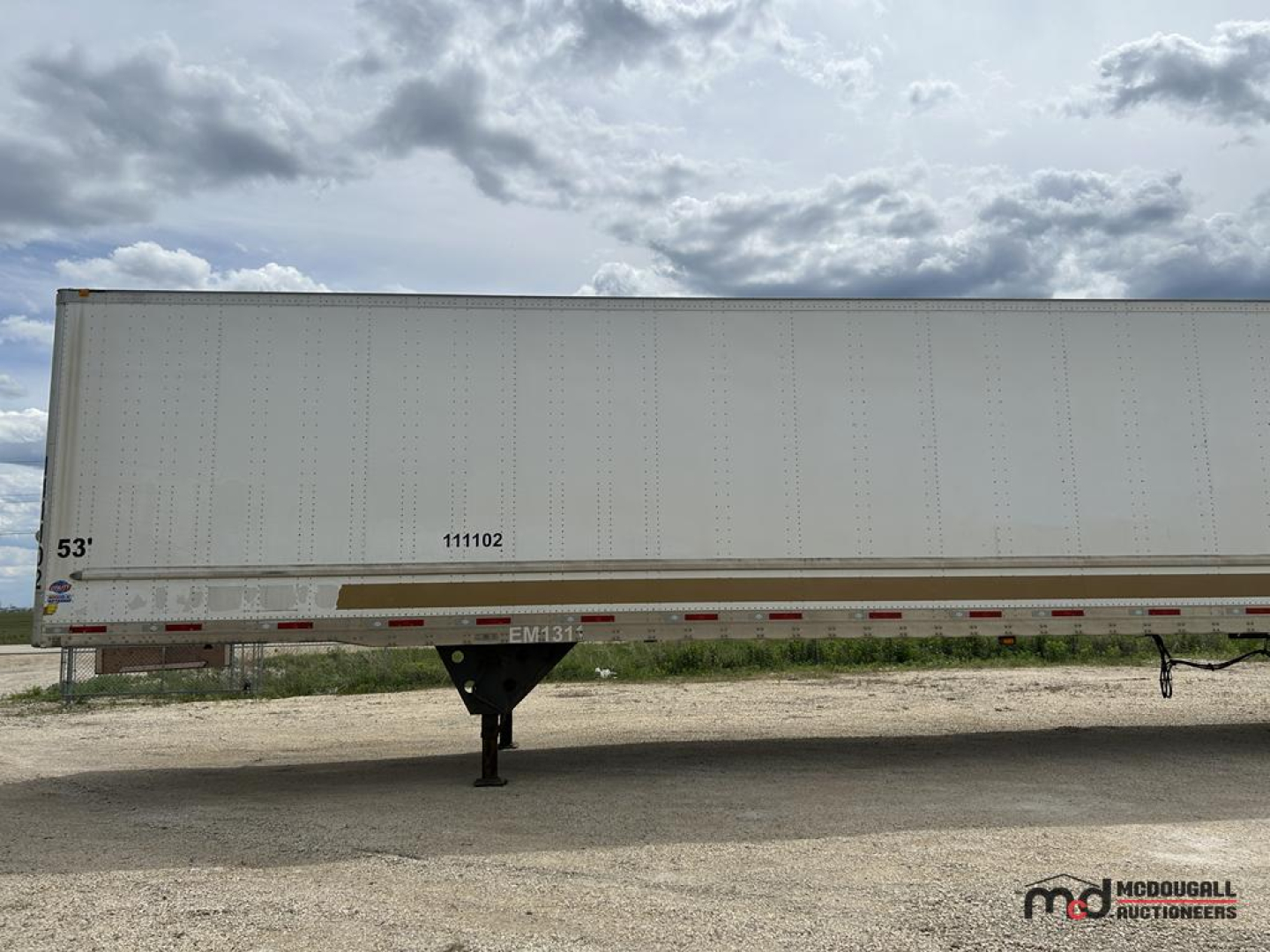 53' dry van trailer side view showing wheel area, registration numbers, and a support jack under the front edge.