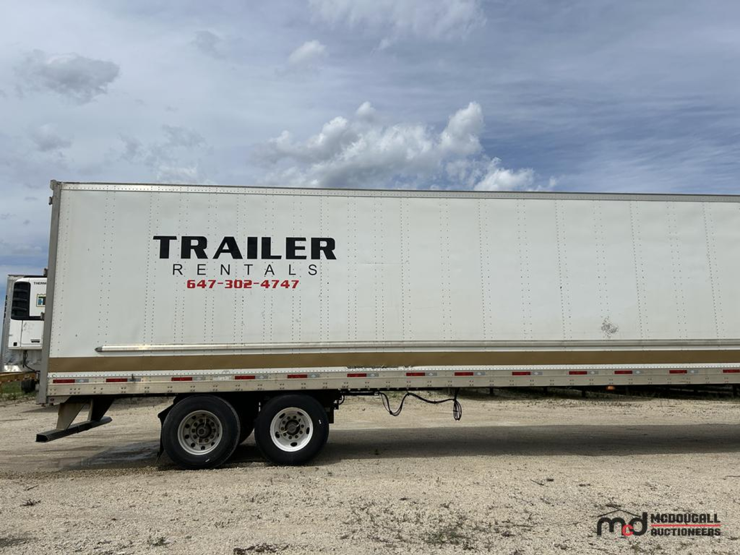 Trailer side showing TRAILER RENTALS text and contact on a 53' dry van trailer