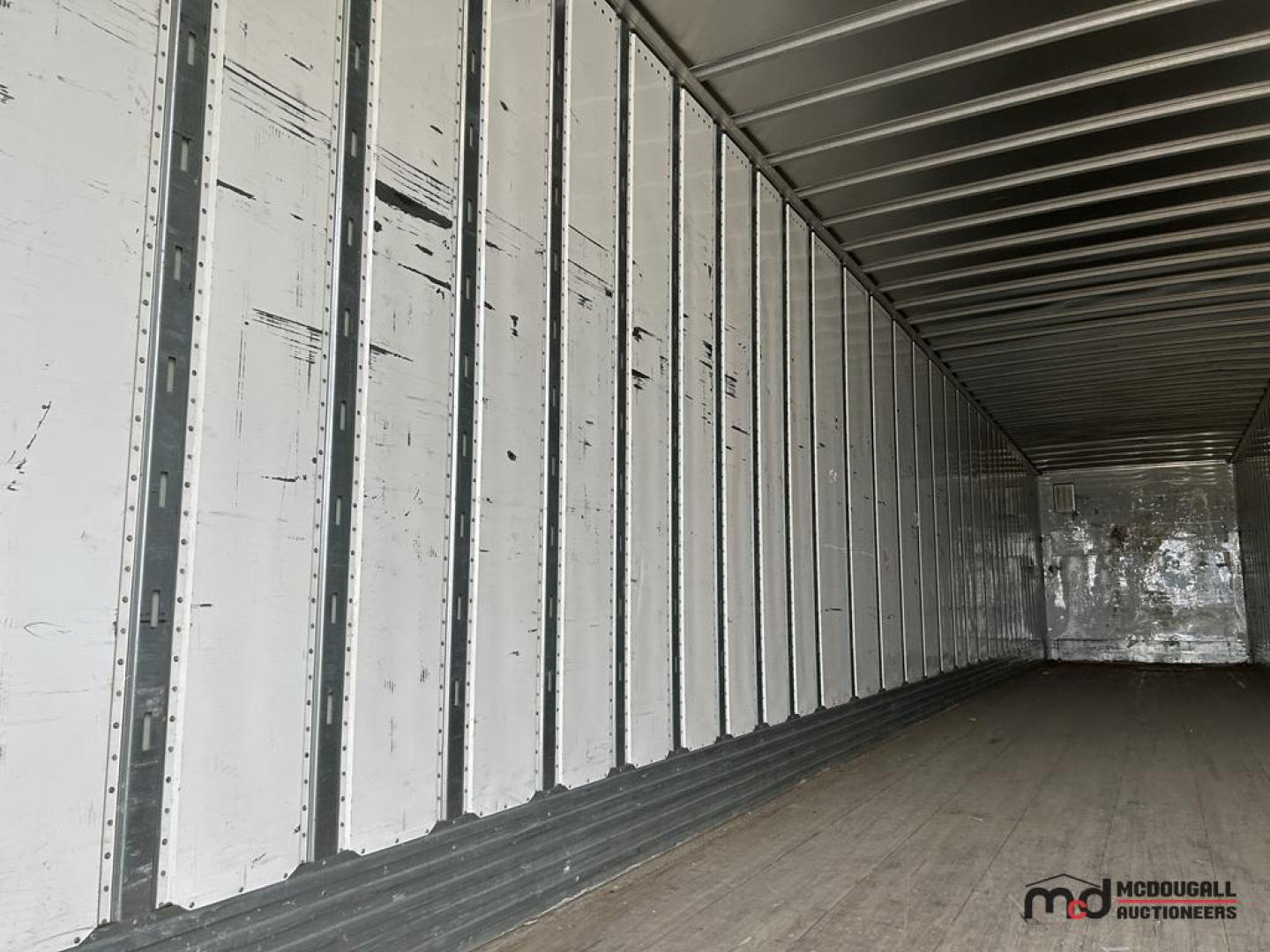 Utility 53' dry van trailer interior showing metal studs and white wall panels, empty cargo area.