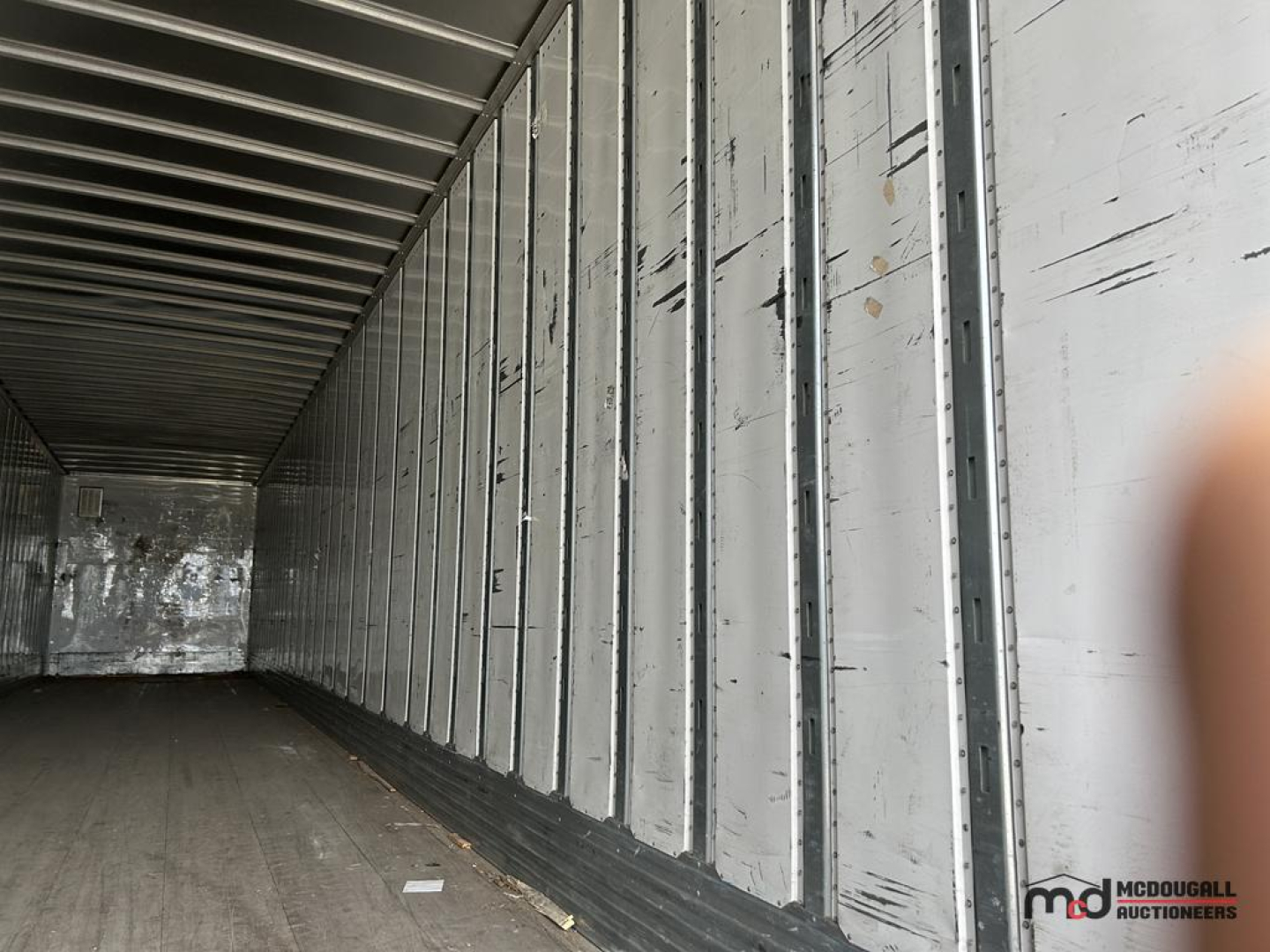 Trailer interior showing vertical metal ribs and walls of a 53' dry van trailer.