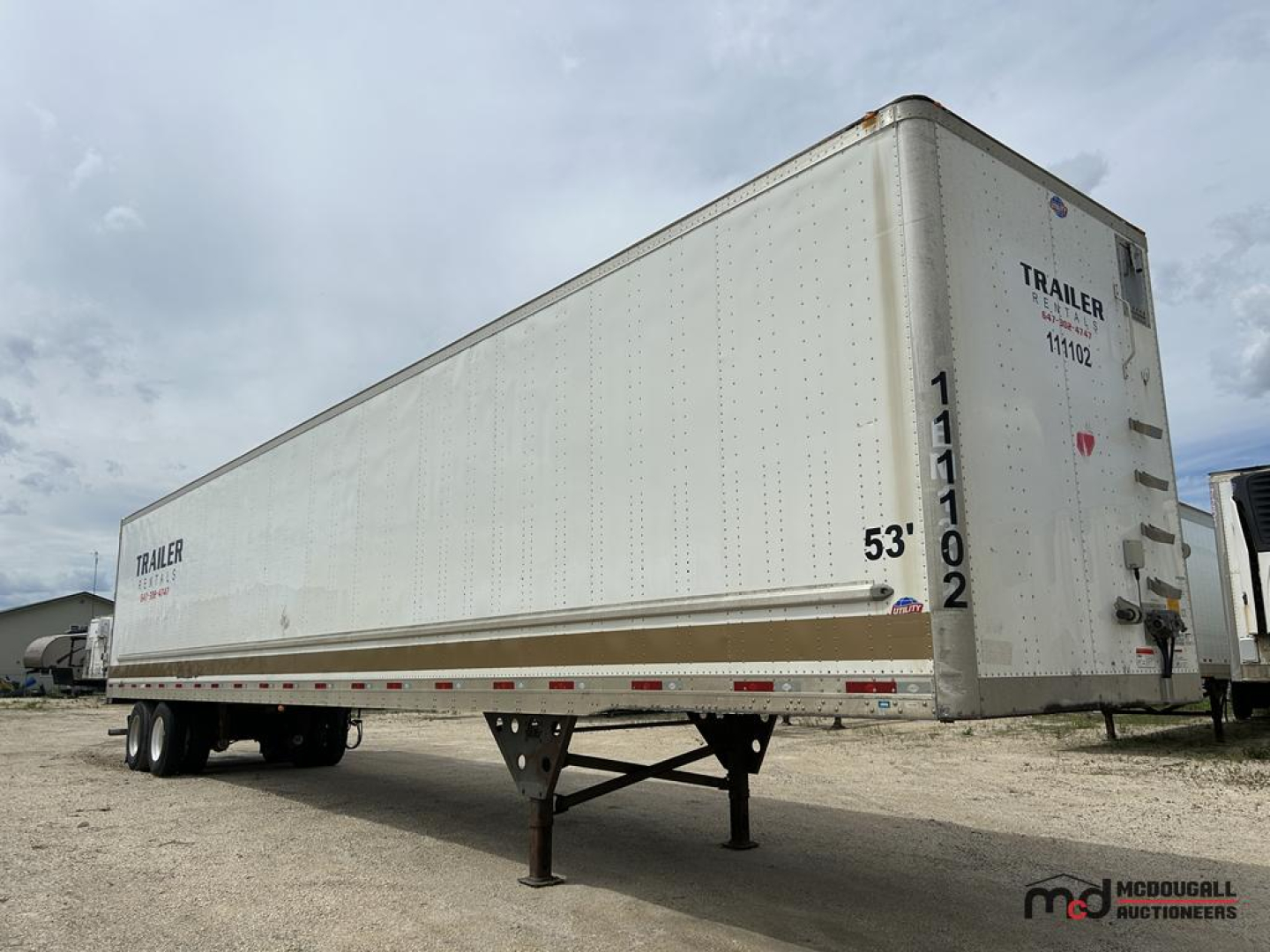 Utility 53' trailer in-service showing side and rear, with 53' measurement and support legs extended, VIN and trailer markings visible.
