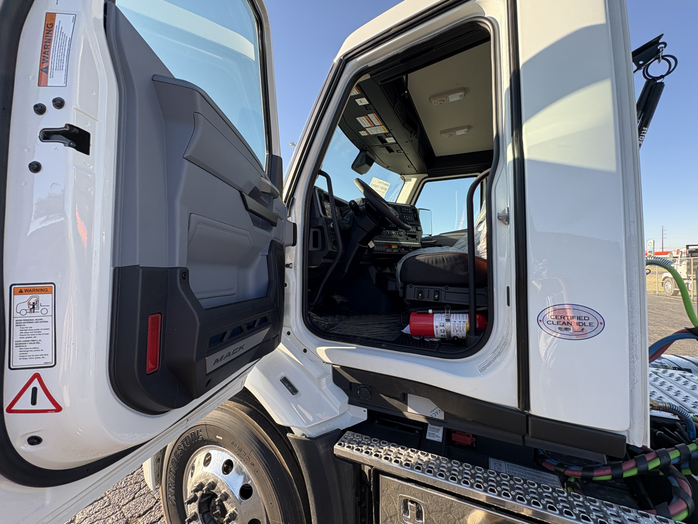 Mack AN64T cab interior showing open door and entry area with stairs and dashboard visible.