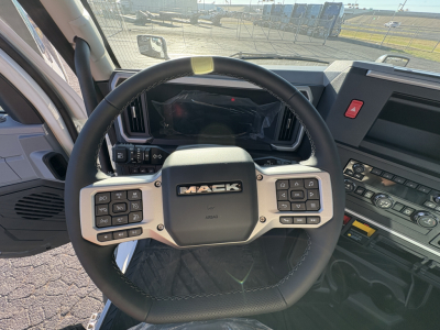 Mack AN64T truck cabin interior with steering wheel showing Mack logo and dashboard controls