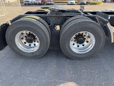 AN64T Mack truck rear axle with dual tires and chrome wheels, chassis frame visible, no cab portion in view.