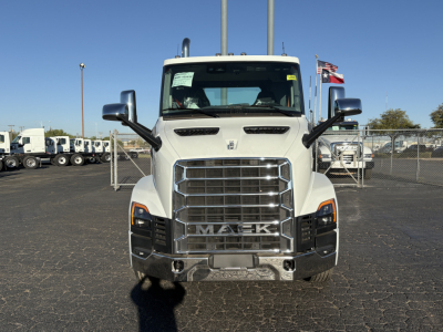 Mack AN64T cab facing camera with chrome grille and side mirrors, front view, in a dealership lot