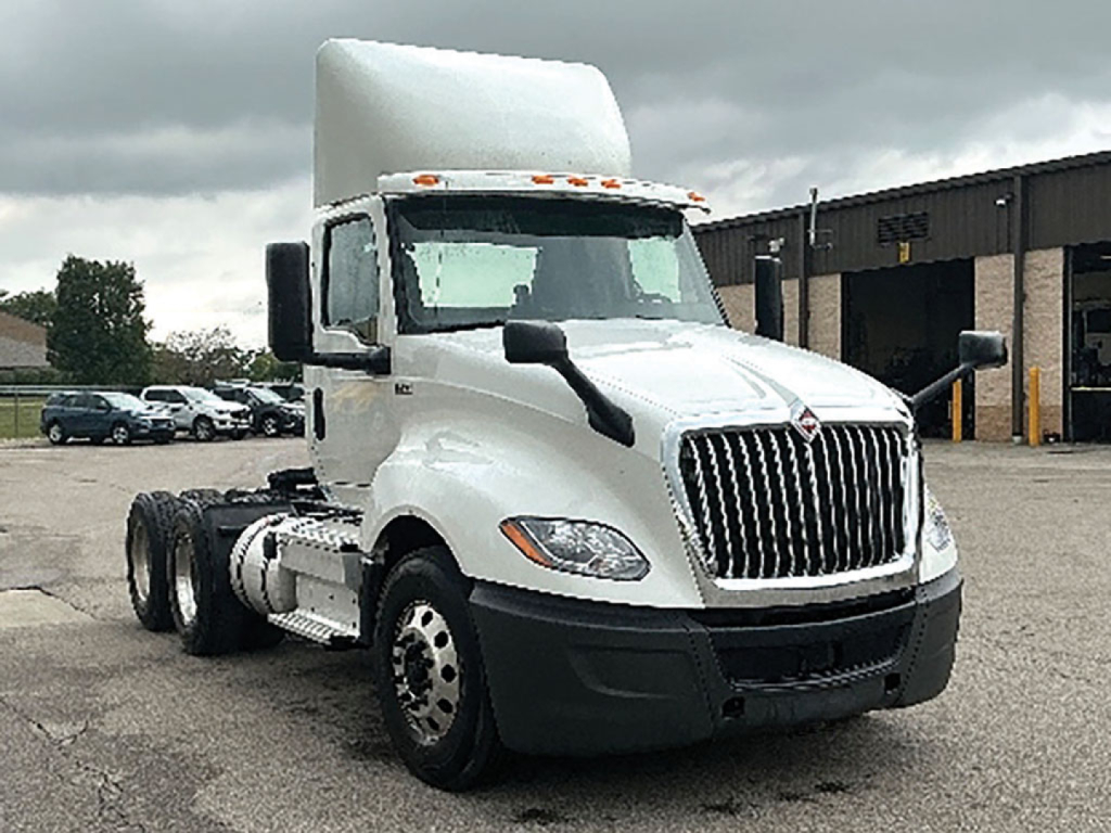 White 2019 International LT625 conventional daycab tractor in a parking lot showing front grille and side view; VIN label and stock number not visible on image.