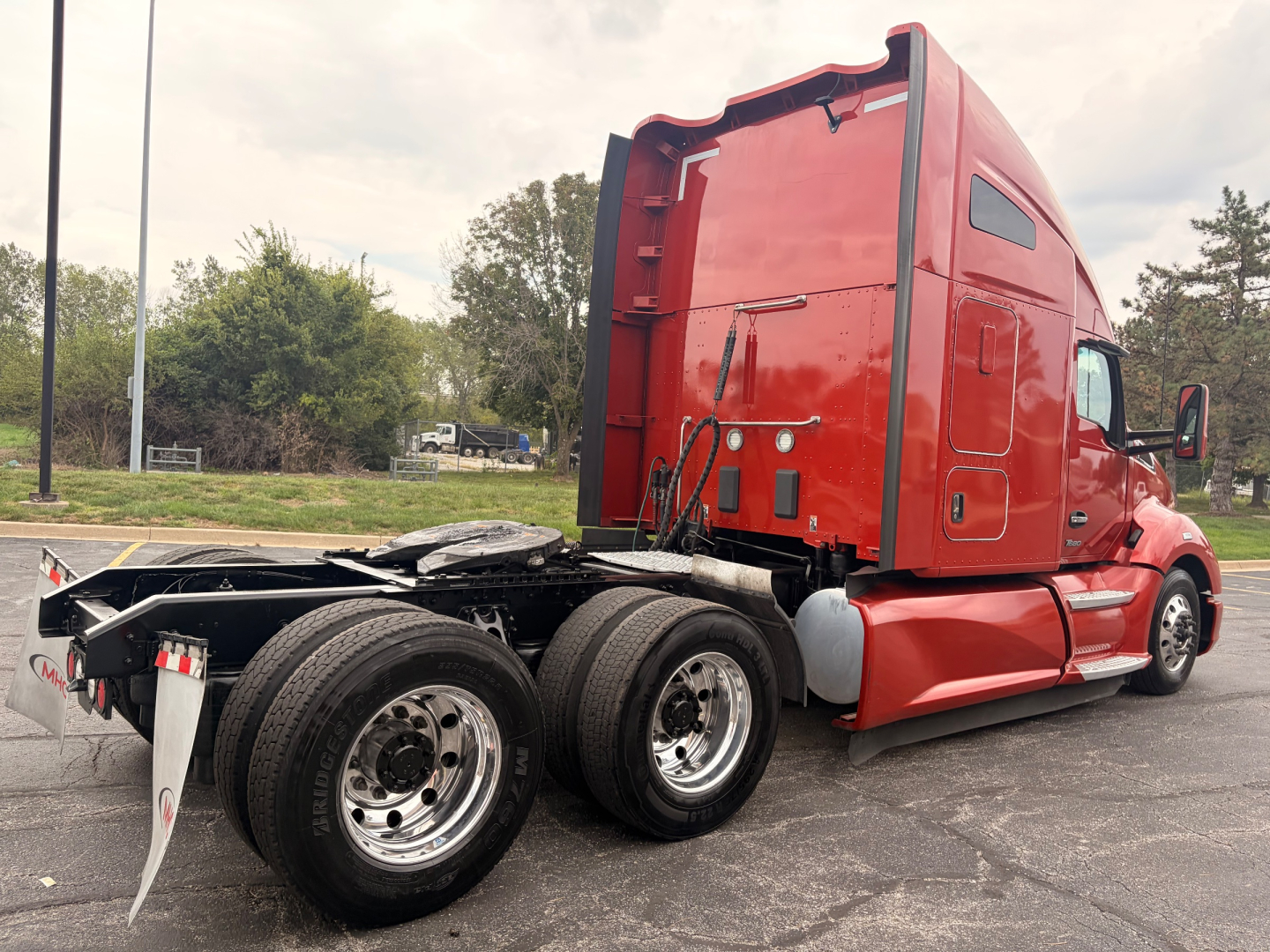 Kenworth T680 truck cab and rear chassis shown from side/rear angle with red paint, tractor wheels, and fifth wheel visible.