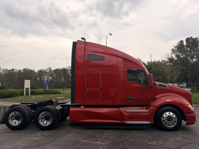 Kenworth T680 sleeper tractor in red side profile showing cab and rear wheels, no visible branding text readable.