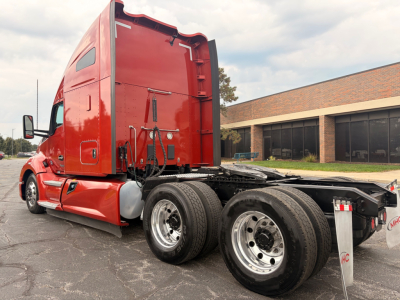 Kenworth T680 6x4 tractor in red, exterior side view showing sleeper cab, chassis with dual rear axles and fifth wheel, no load tags visible.