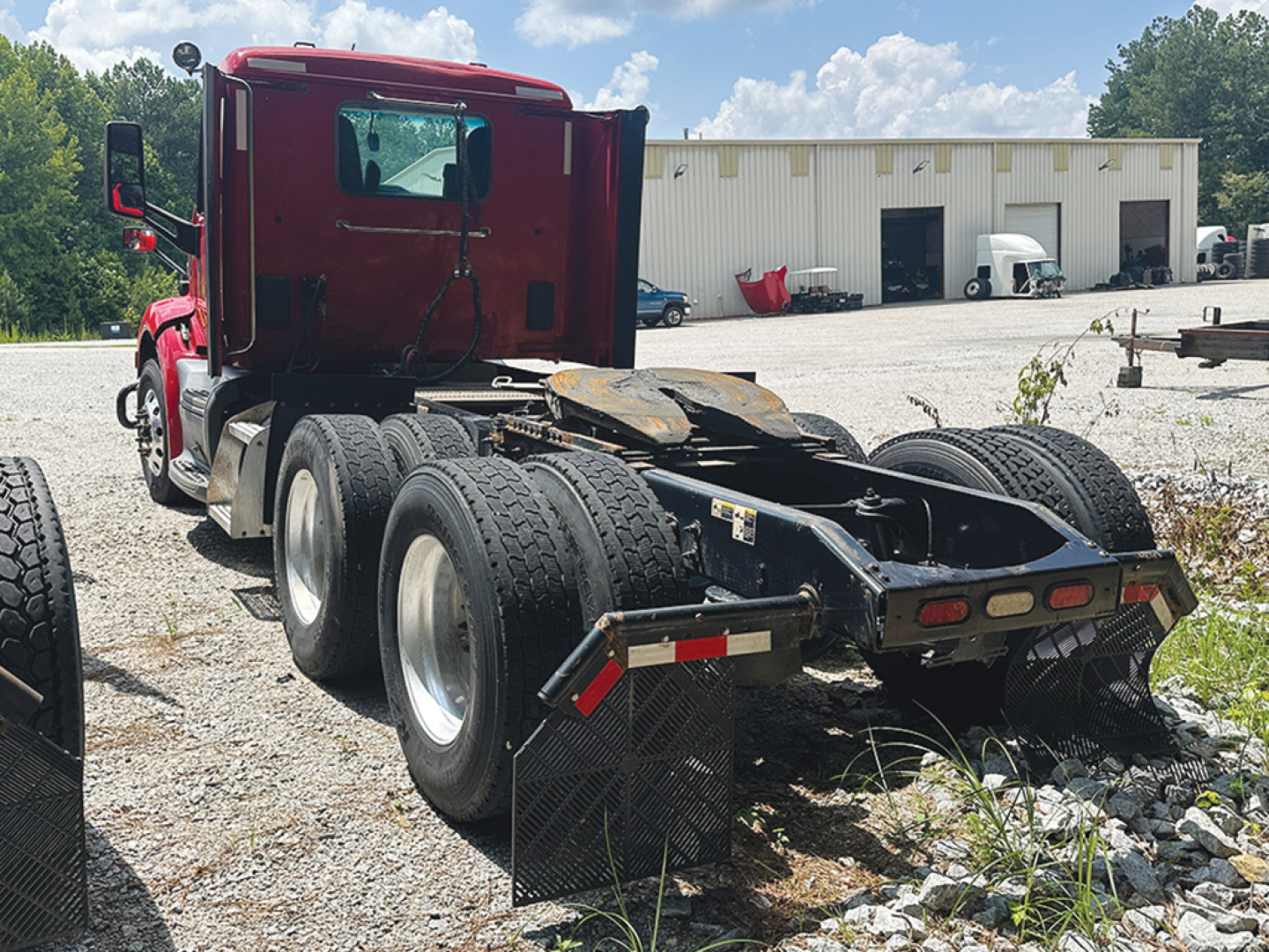 Peterbilt 579 tractor with 3-axle rear chassis view showing fuel tanks and wheels