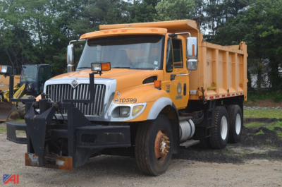 2006 International WorkStar 7400 dump truck in orange with front bumper guard and dump bed visible.