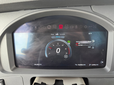 Kenworth T680 truck instrument cluster display showing digital speedometer at 0 MPH, fuel and DEF gauges, and trip odometer; VIN and stock info not on image.
