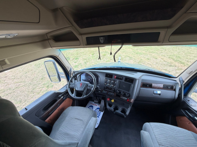 Kenworth T680 truck interior view of cab, steering wheel, dashboard, and driver seat.