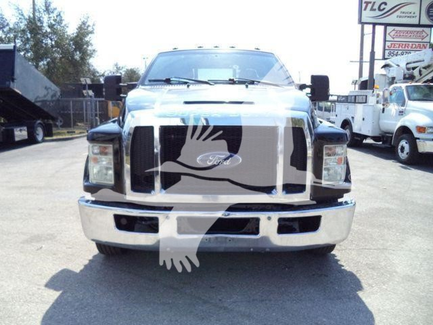 Front view of a Ford F-650 truck with large grille; no legible text visible on vehicle.