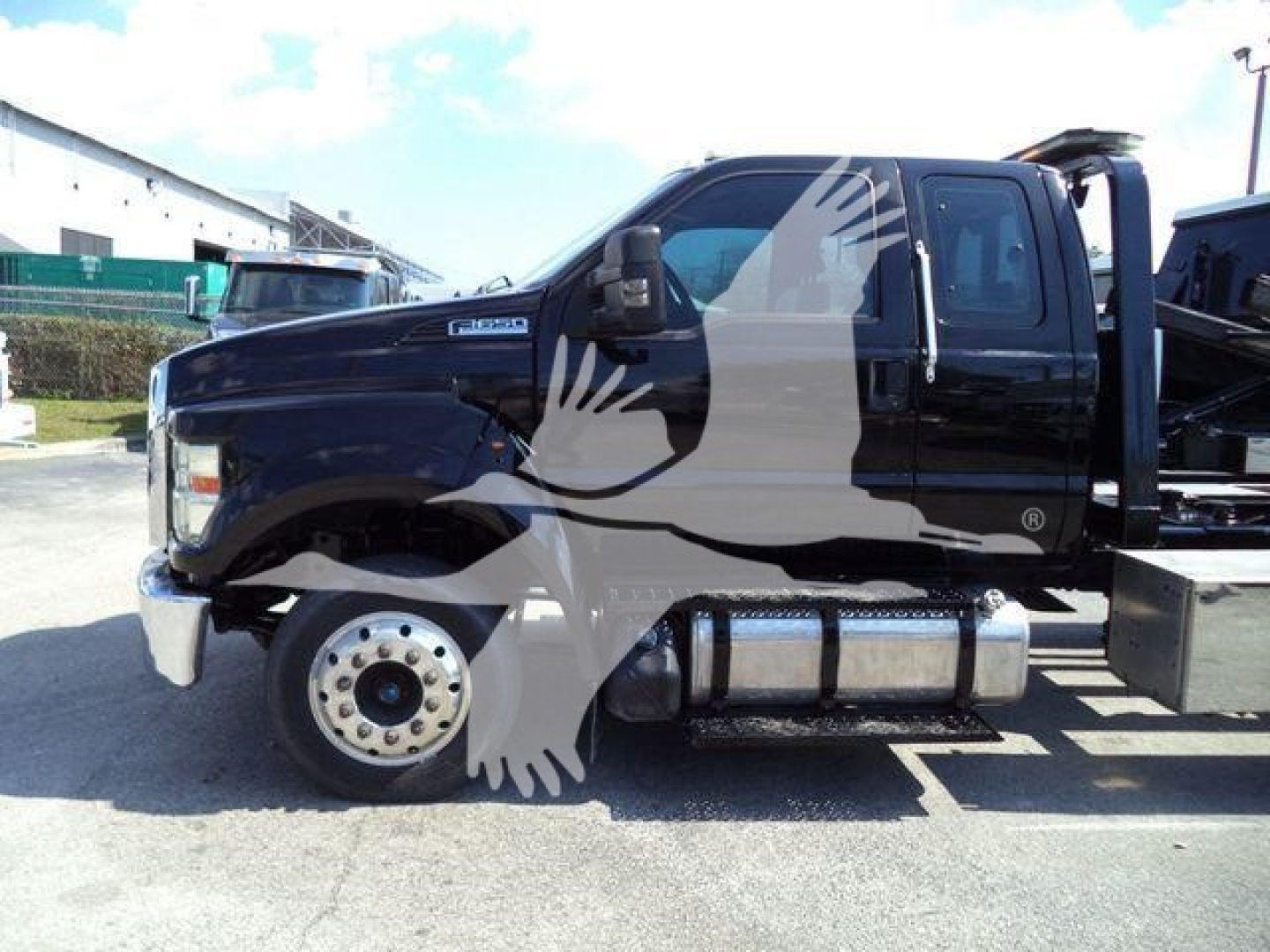 Ford F-650 rollback truck side view showing fuel tank and cab with dual rear wheels.