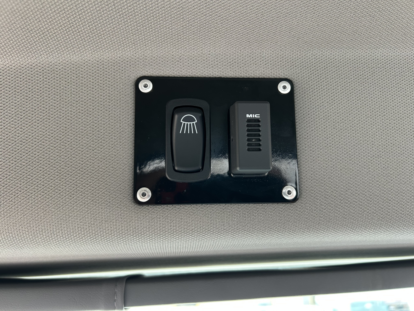 Mack MD7 dashboard panel showing a headlamp wash/wiper switch and a mic switch in a black rectangular plate