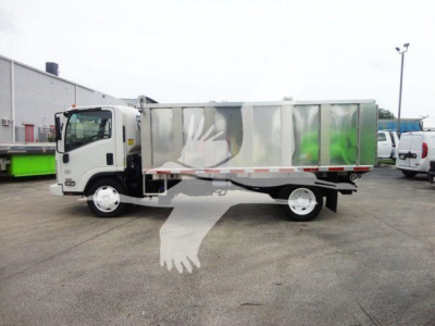 Isuzu NPR/NQR dump truck side view with metal dump bed and logoed sides. Visible text not legible; truck in a dealership lot.