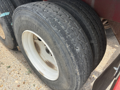 Dual rear tires on a trailer showing tread and white wheel rims.