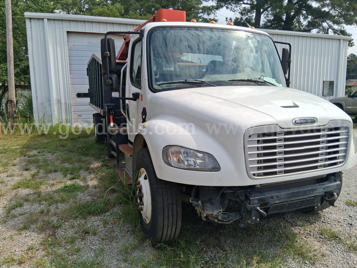 Truck front view of a 2014 Freightliner Grapple with hydraulic arm and metal framework on bed, VIN 1FVACDT1EHFU8003.