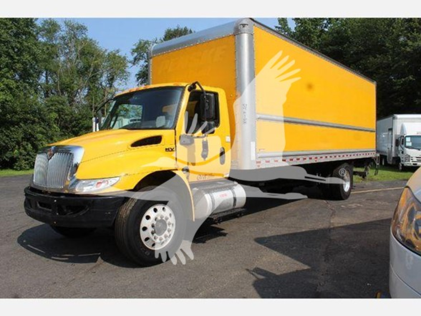 2020 International MV box truck showing bright yellow cab and box with white trim.