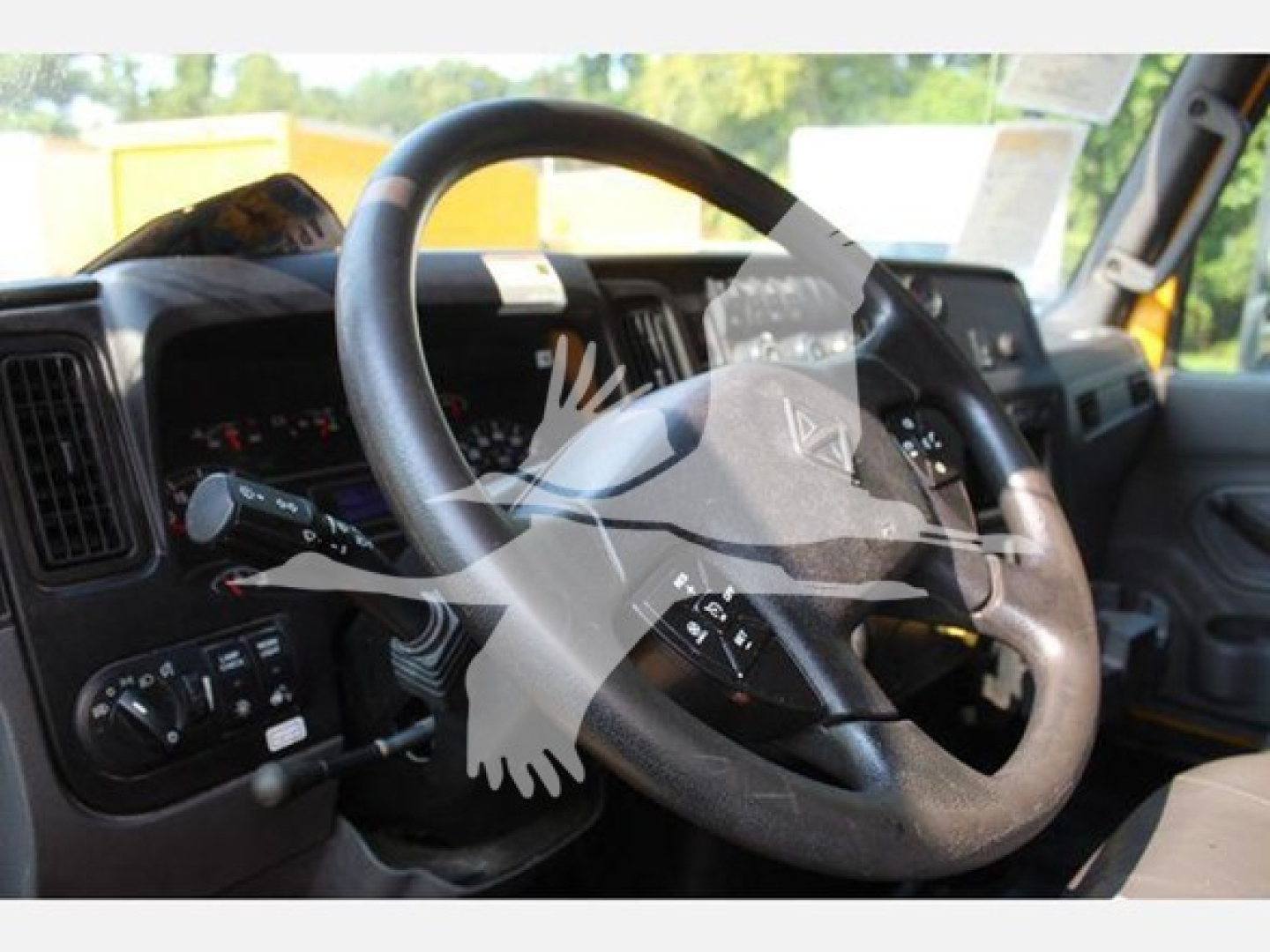 Interior cockpit view of a 2020 International MV truck showing steering wheel, dashboard, and control stalks.