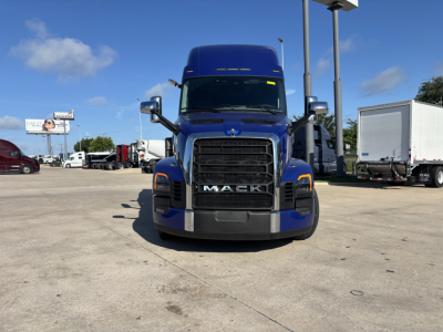Front view of a blue Mack truck PR64T76H showing the grille with MACK lettering, headlights, and side mirrors.