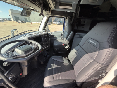 Mack PR64T76H tractor cab interior showing driver seat and dashboard with controls.