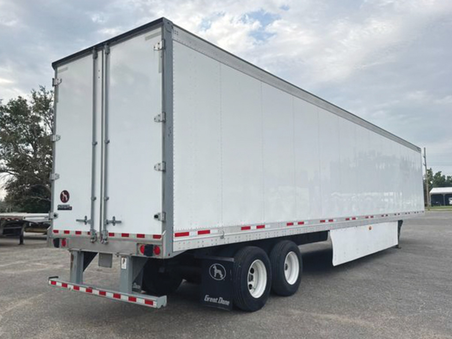 Great Dane Champion SE trailer showing side and rear with dual rear wheels, white exterior, taillights and safety reflectors.