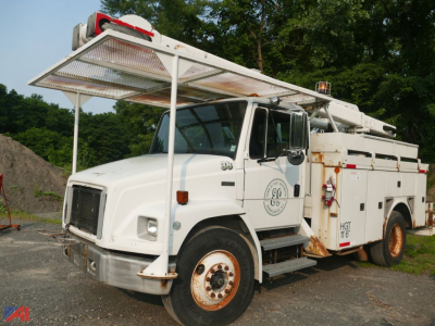 Bucket truck in-service white Freightliner FL70 with hydraulic boom and platform, side compartments, and orange wheel rims.