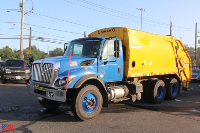 2019 International New Way WorkStar 7400 Packer Truck in blue cab with yellow rear body, side view showing front grille and dual rear wheels.