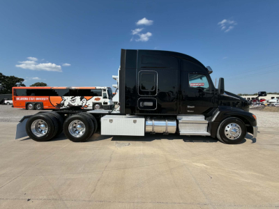 Kenworth T680 conventional sleeper tractor in black, side profile view with fuel tanks and chrome steps.