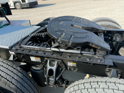 Kenworth T680 chassis rear view showing fifth wheel coupling and air/connectors with black metal framework and coil spring suspension.