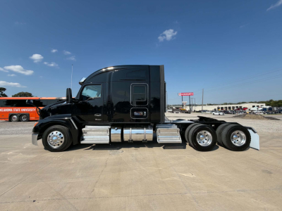 Kenworth T680 tractor profile with black cab and dual rear axles, side steps, fuel tanks, and chrome accents.