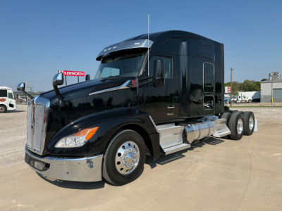 Kenworth T680 tractor in black, front three-quarter view, side fuel tanks, chrome bumper and wheels, sleeper cab, VIN tag not visible.