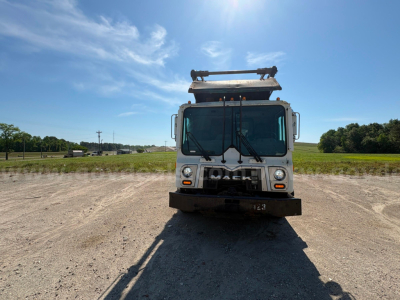 Front view of a 2013 Mack MRU613 garbage truck showing Mack grille, headlights, and front bumper in service condition.