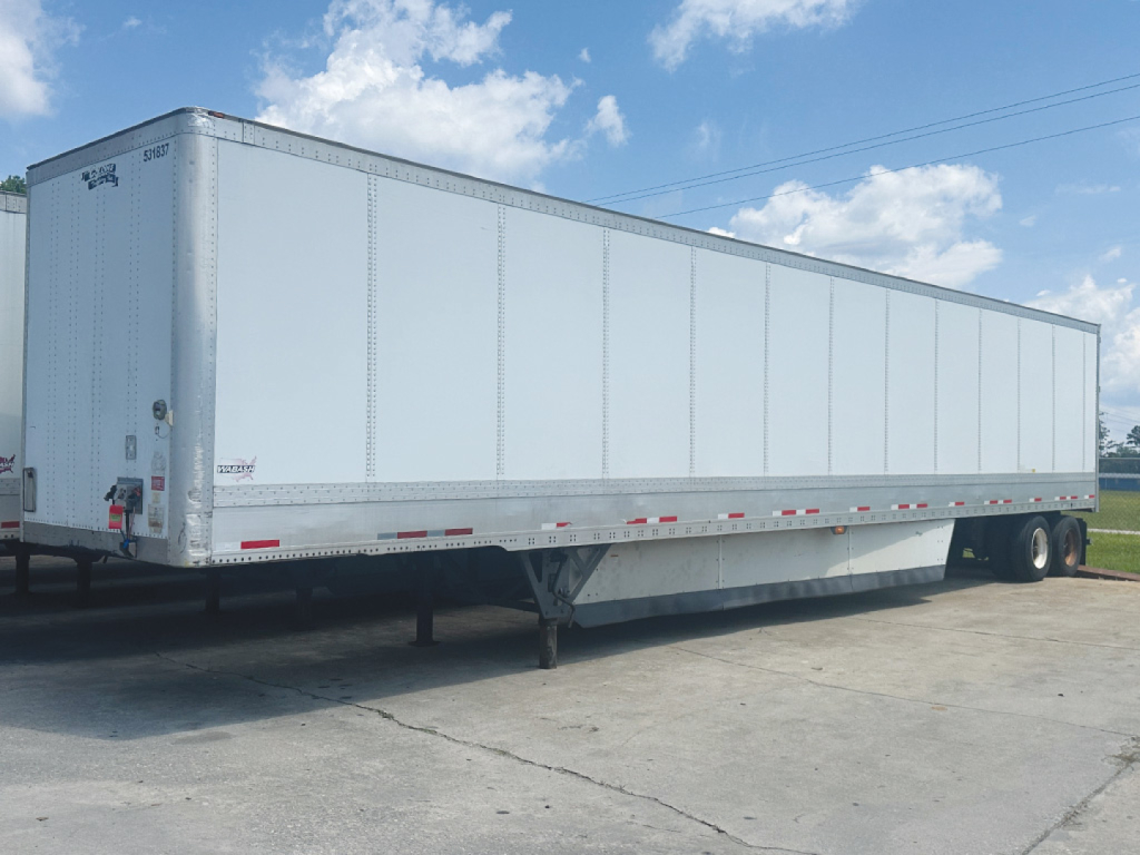 Trailer side view of a white 2017 Wabash DuraPlate HD van trailer with support legs and undercarriage visible.