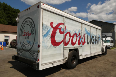 Truck box showing Coors Light branding on beverage delivery truck, rear and side panels with Coors Light logo and mountains.