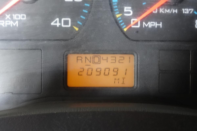 Dashboard odometer display showing RN D4321 and 209091 miles in an International 4300 cab from 2004.