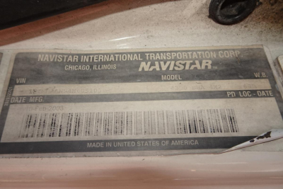 Identification plate on Navistar International Transportation Corp. cab showing NAVISTAR model plate with VIN and date info, MADE IN UNITED STATES OF AMERICA, CHICAGO ILLINOIS, PD LOC - DATE.