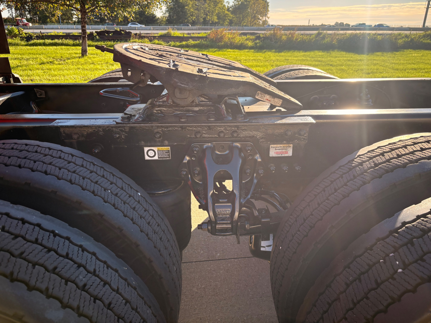 Kenworth T680 chassis showing fifth wheel and dual rear axles with mount hardware and fuel lines visible