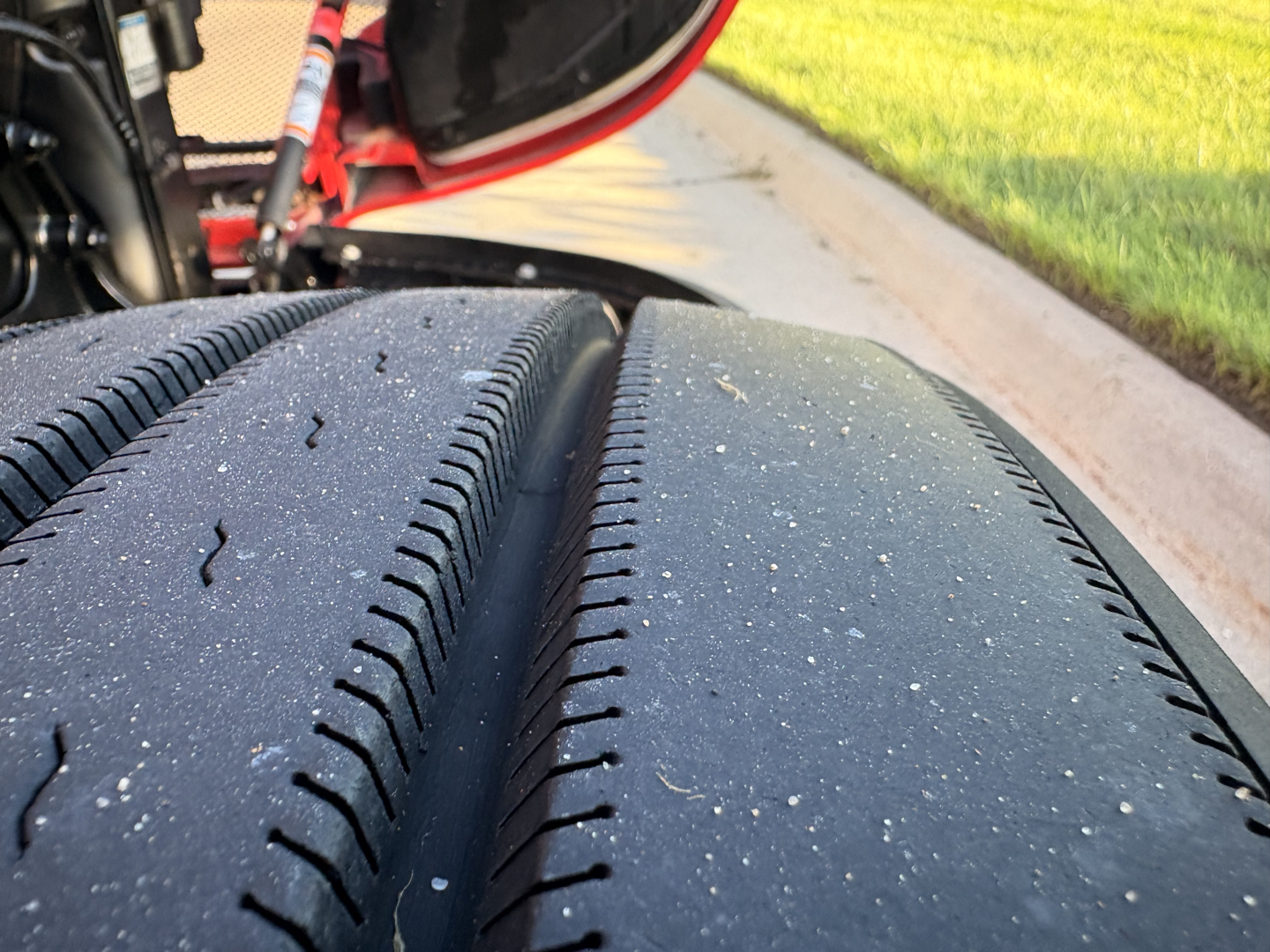 Kenworth T680 wheel and tire close-up view in-service with visible tread and asphalt grit.