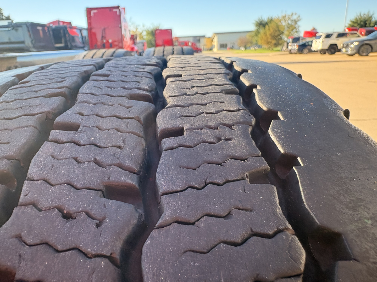 Kenworth T680 truck tire tread close-up in a dealership lot.