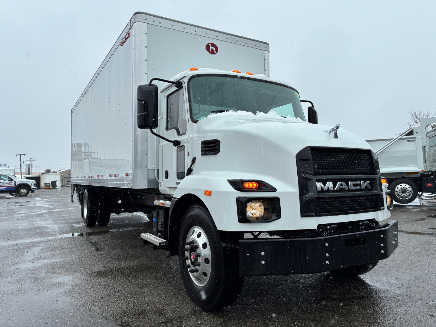 Box truck front-left view of a white 2025 Mack MD6 with a large box body, black grille, and dual rear wheels; VIN tag and stock number not visible on the image.
