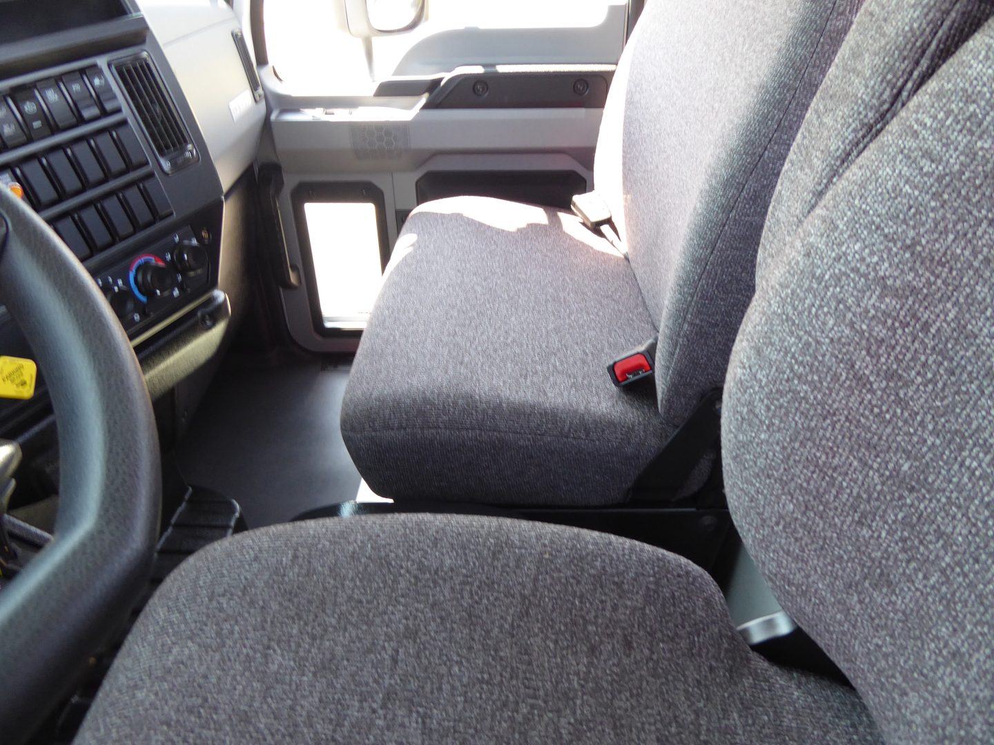 Cab interior of a 2025 Mack MD6 showing front seat and dashboard area with steering wheel and control panel.