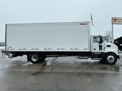 Truck side view of a new 2025 Mack MD6 box truck showing long rectangular cargo body and cab with white exterior.