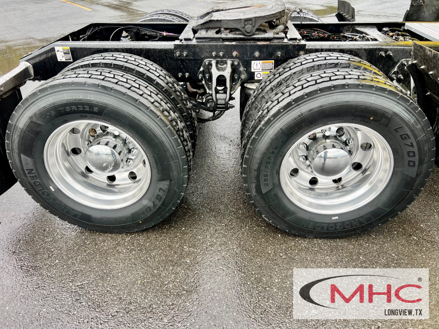 Peterbilt 579 chassis showing dual rear axles with chrome wheels and tires, undercarriage, and frame rails visible.