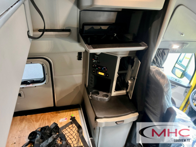 Peterbilt 579 cab interior showing driver area with cabinet, control panel, and storage drawer.